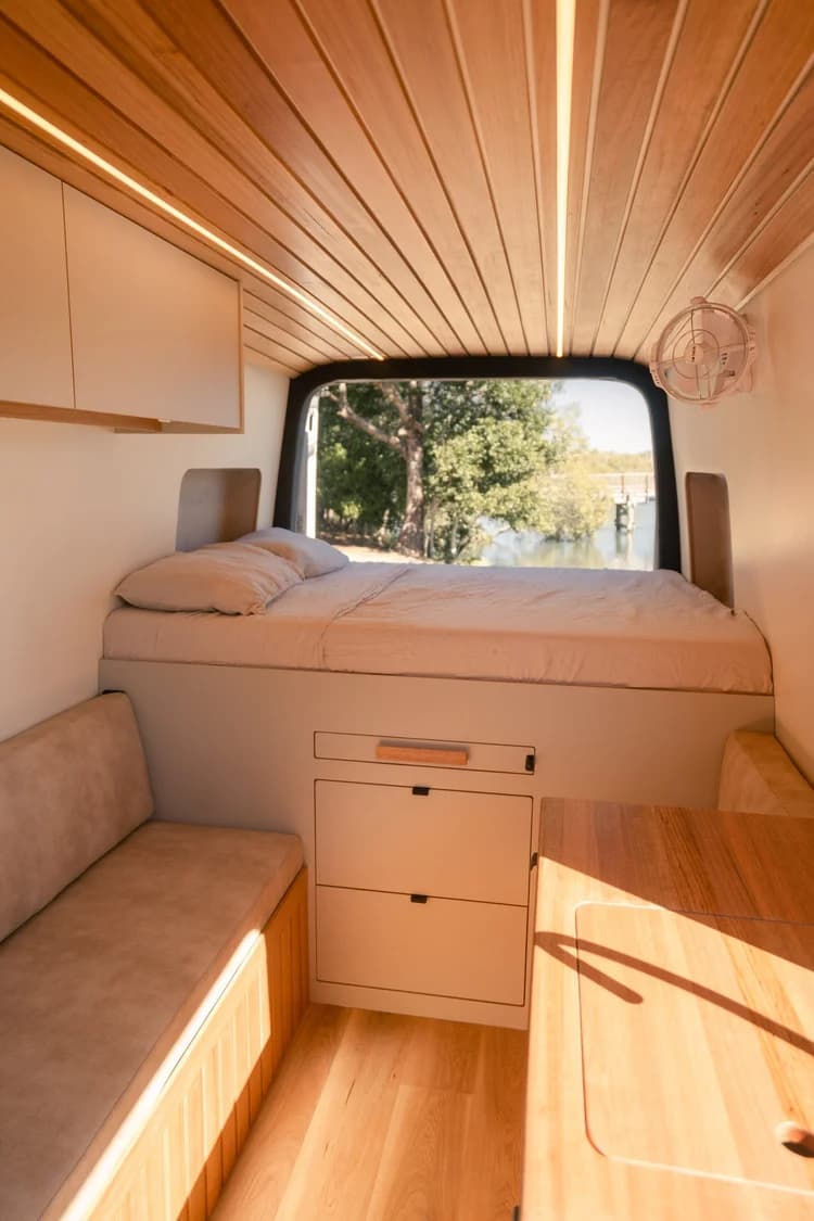 Bed above deep drawers, with bench seating and hand-finished timber cabinetry